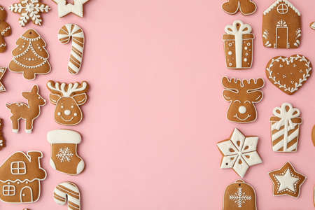 Different Christmas gingerbread cookies on pink background, flat lay. Space for textの写真素材