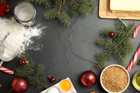 Flat lay composition with ingredients for traditional Christmas cake on gray table. Space for textの写真素材