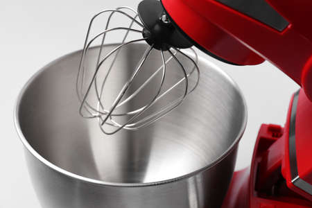 Modern red stand mixer on light gray background, closeup