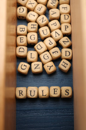 Word Rules made of cubes with letters on blue wooden table, flat layの写真素材