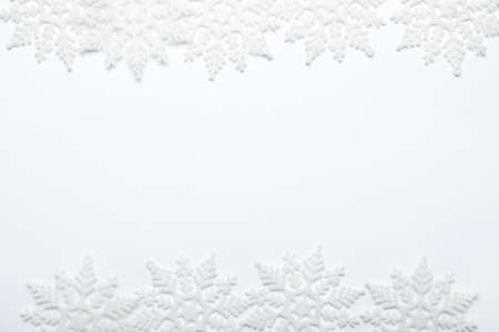 Beautiful decorative snowflakes on white background, flat lay. Space for textの写真素材