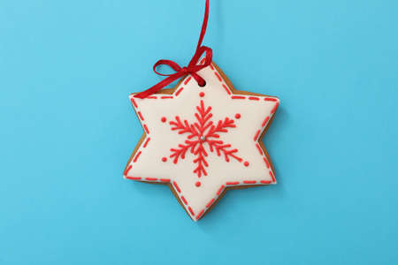 Snowflake shaped Christmas cookie on light blue background, top viewの写真素材