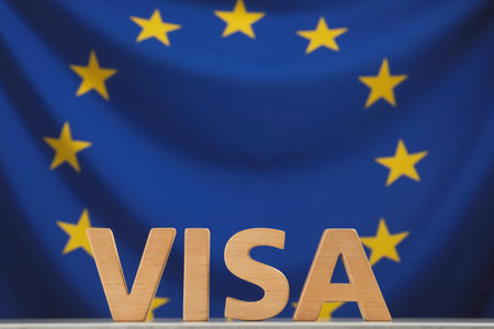 Word Visa made of wooden letters on table against European Union flag. Space for textの写真素材