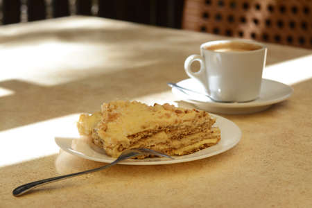 Piece of delicious cake and coffee on beige table, closeupの写真素材