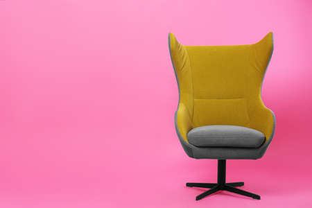 Comfortable office chair on pink background, space for textの写真素材