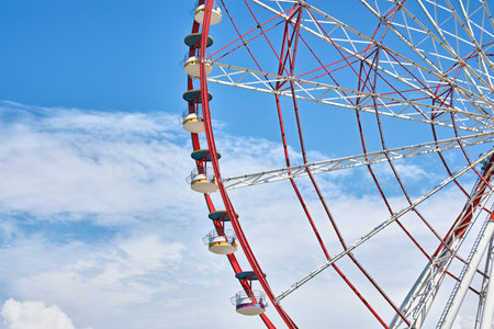 Beautiful large Ferris wheel against cloudy skyの写真素材