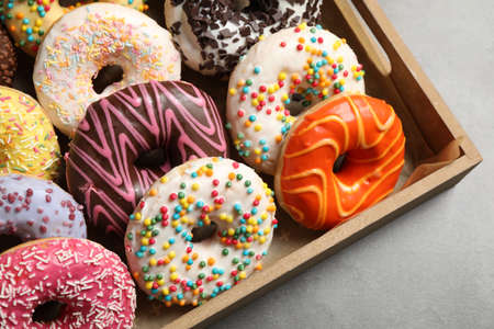 Yummy donuts with sprinkles in box, closeupの写真素材