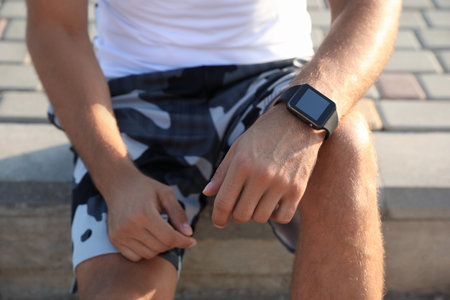 Man with fitness tracker after training outdoors, closeupの写真素材