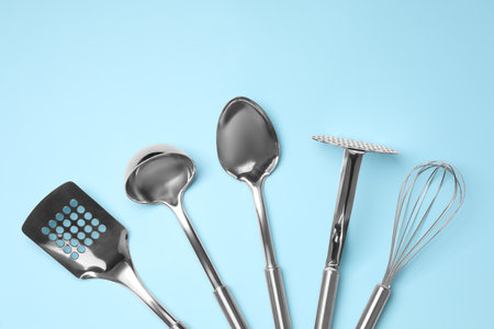 Set of modern cooking utensils on light blue background, flat layの写真素材