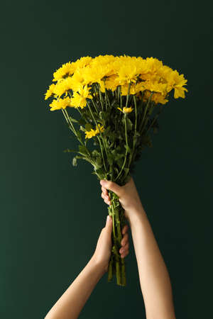 Woman holding beautiful bouquet near green chalkboard. Happy Teacher's Dayの写真素材