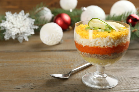 Traditional russian salad Mimosa and festive decor on wooden table. Space for textの写真素材