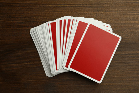 Deck of playing cards on wooden table, top view. poker game