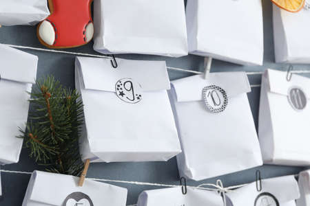 Advent calendar with gifts hanging on gray wall, closeup. christmas seasonの写真素材