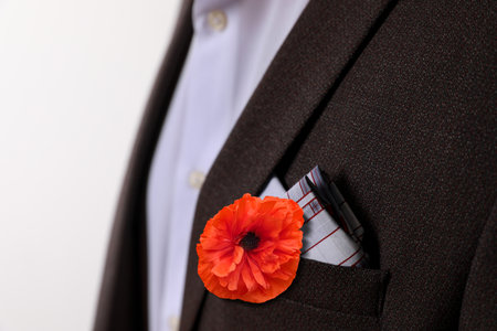 Man with red poppy flower in suit pocket, closeup view. Remembrance symbolの写真素材