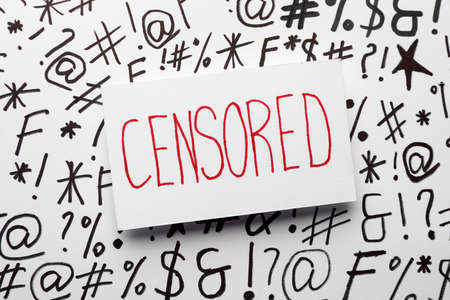 Word Censored on white paper with different symbols, top viewの写真素材