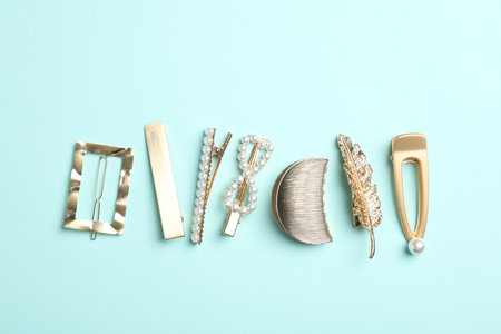 Stylish hair clips on light blue background, flat layの写真素材
