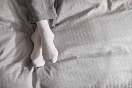 Woman wearing socks on gray blanket, top view. Space for textの写真素材