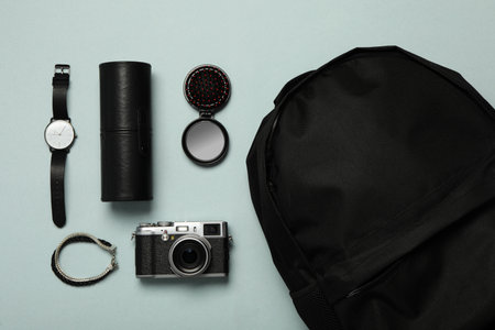 Stylish urban backpack with different items on light background, flat lay