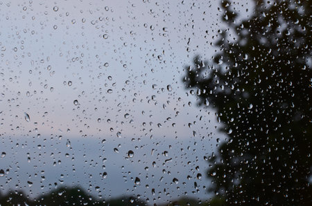 Window glass with water drops, closeup. Rainy weatherの写真素材