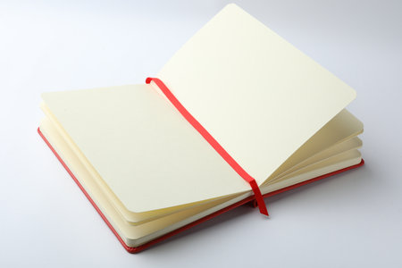 Stylish open notebook with blank sheets isolated on whiteの写真素材