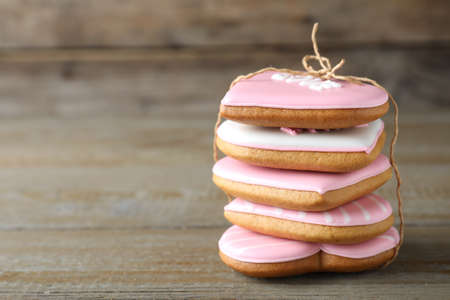 Stack of Valentine's day cookies on wooden table, closeup. Space for textの写真素材
