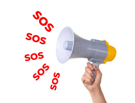 Woman holding megaphone and words SOS on white background. Asking for helpの写真素材