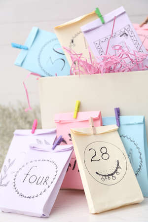 Colorful paper bags on white table, closeup. new year advent calendarの写真素材