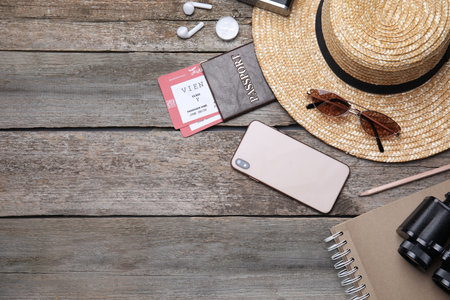 Flat lay composition with passport and tickets on wooden table. Space for text