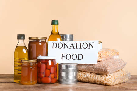 Card with words Donation Food and different products on wooden tableの写真素材