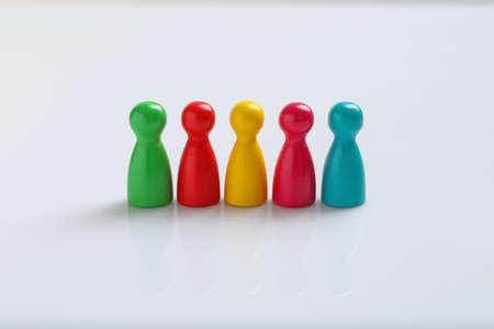 Colorful pawns on white background. social inclusion conceptの写真素材