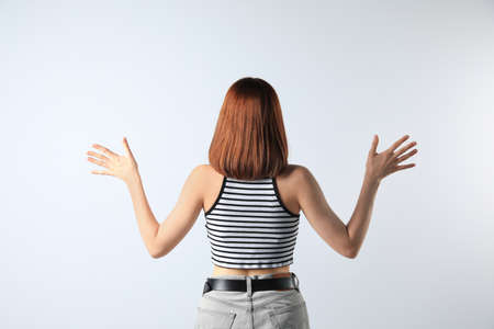 Girl wearing striped top on white background, back viewの写真素材