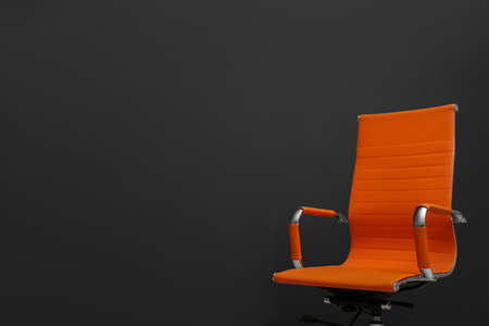Comfortable office chair on black background. Space for textの写真素材