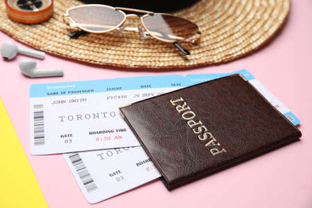 Passport with tickets near travel items on color background, closeupの写真素材