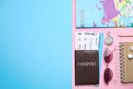 Flat lay composition with passport, tickets and travel items on color background. Space for textの写真素材