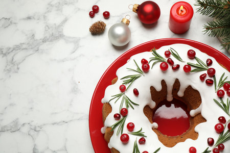 Flat lay composition with traditional homemade Christmas cake on white marble table, space for textの写真素材