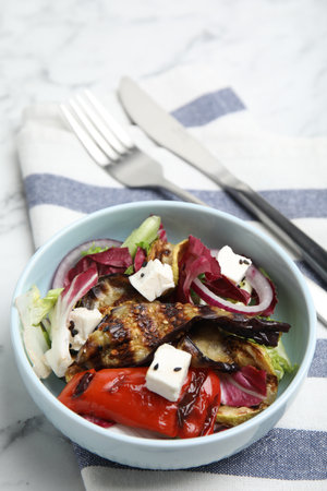 Delicious salad with roasted eggplant, feta cheese and chia seeds served on tableの写真素材