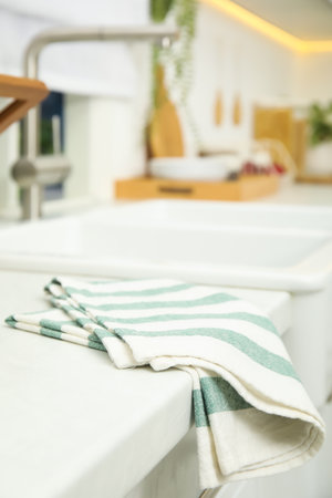 Clean towel near white sink in kitchenの写真素材