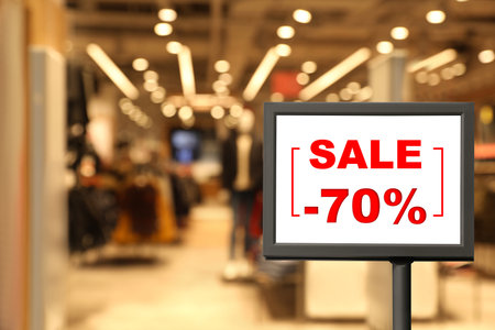 Sign with text SALE and 70 percent discount in shopping mall. special promotion