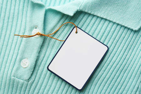 Blank tag on tshirt, top view. Space for textの写真素材