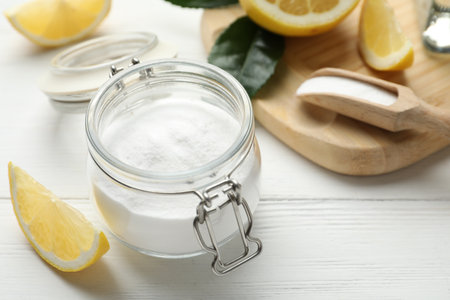 Baking soda and cut lemons on white wooden tableの写真素材