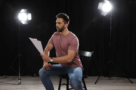 Professional actor reading his script during rehearsal in theater