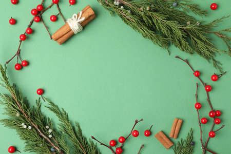 Christmas flat lay composition with conifer branches and berries on green background, space for text. Winter holidaysの写真素材