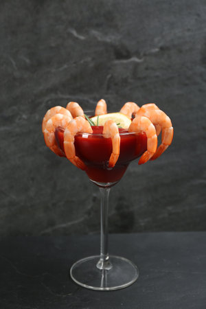 Delicious shrimp cocktail with tomato sauce served on black tableの写真素材