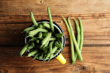 Fresh green beans on wooden table, flat layの写真素材