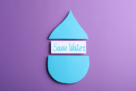 Words Save Water between parts of paper drop on purple background, flat layの写真素材