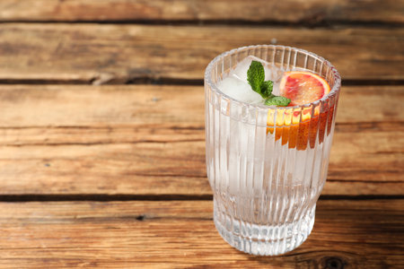 Delicious refreshing drink with sicilian orange and mint on wooden table. Space for textの写真素材