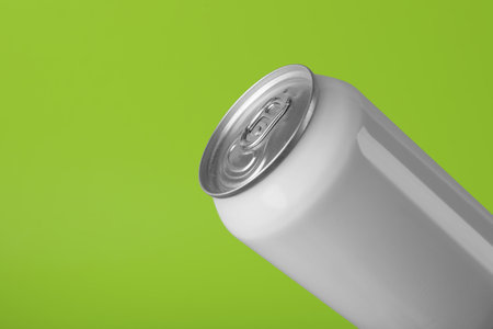 White can of energy drink on light green background, closeup. Space for textの写真素材