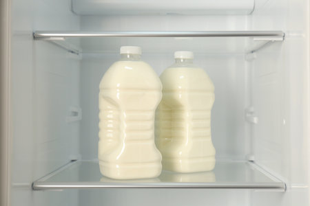 Gallons of fresh milk in refrigerator, closeupの写真素材