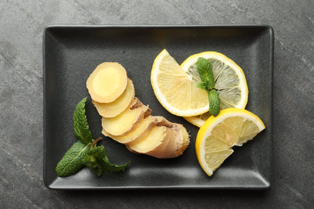Fresh lemon, ginger and mint on gray table, top viewの写真素材