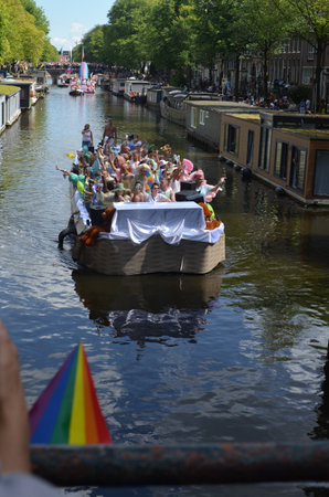 AMSTERDAM, NETHERLANDS - AUGUST 06, 2022: Many people in boat at LGBT pride parade on riverのeditorial素材